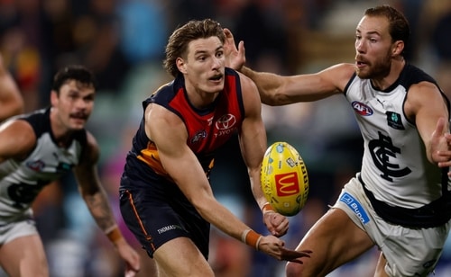 Josh Worrell handpassing during an Adelaide Crows match