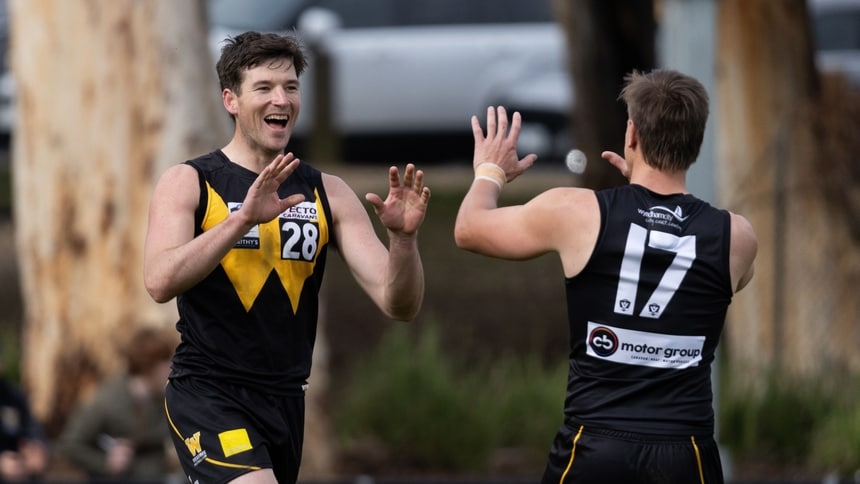 Brady Wright celebrates a goal with Harry Maguire. Picture Belinda Vitecca