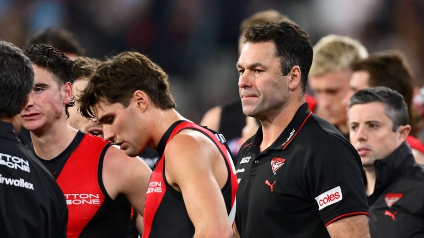Dean Solomon speaks to Essendon players during round 13, 2026. Picture: AFL Photos/Getty Images