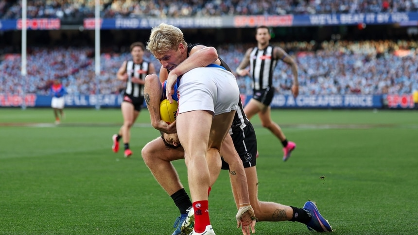 Brody Mihocek is tackled by Billy Frampton during the match between Collingwood and Melbourne in R13, 2026. Picture: AFL Photos