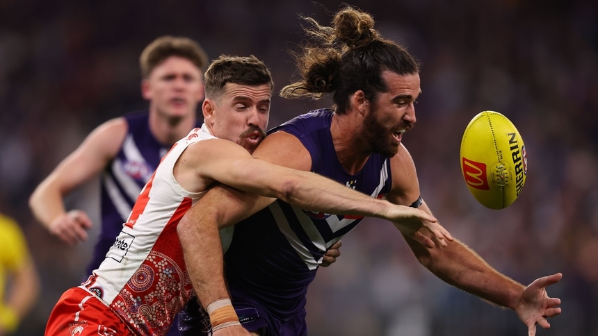 Jake Lloyd and Alex Pearce contest the ball in the match between Fremantle and Sydney at Optus Stadium in round 18, 2026. Picture: Getty Images